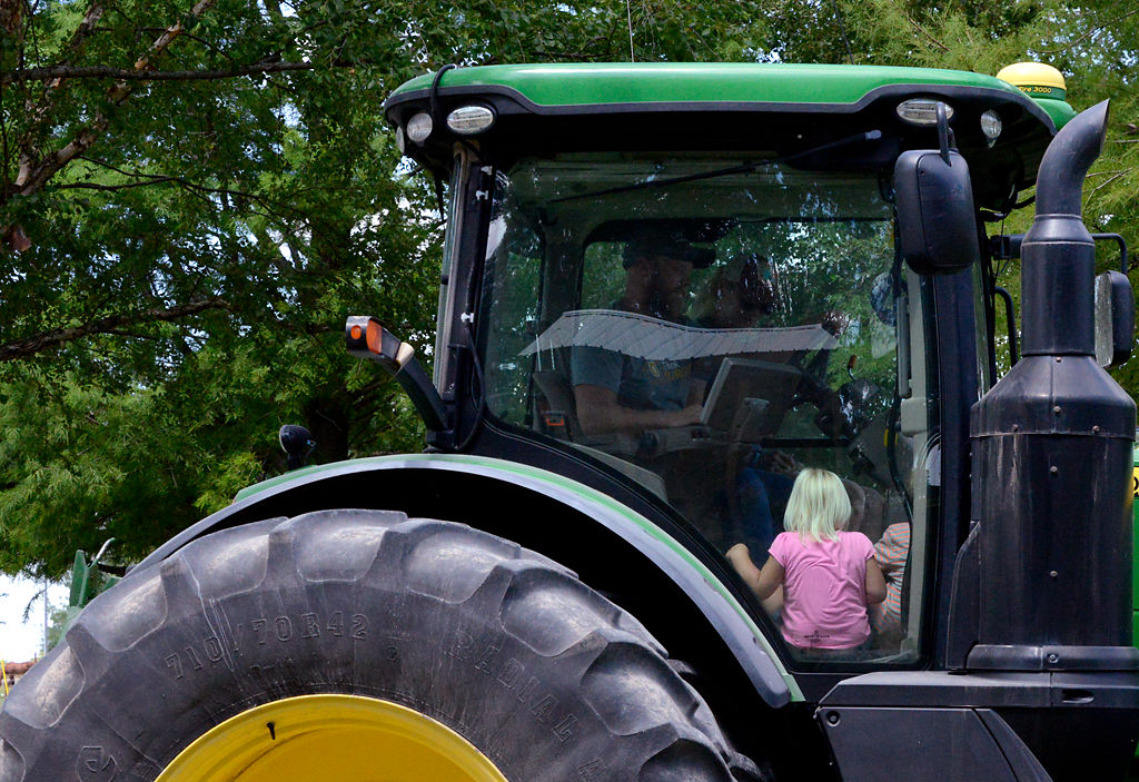 Clara Lorentzen sits in her father's tractor